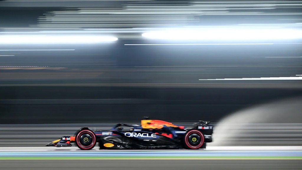 F1 car at speed with aerodynamic wake trailing behind